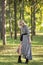 Fashion style portrait of gorgeous beautiful woman posing in summer green park