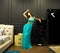 Fashion style portrait of young beautiful pretty elegant rich woman wearing evening dress in luxury apartments
