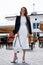 Fashion style street look elegant brunette woman walk cafe restaurant date meeting businesswoman success wear white dress and