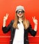 Fashion stylish cool girl having fun wearing a rock black leather jacket and sunglasses with hat