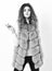 Fashion trend concept. Winter fashionable wardrobe for female. Boutique selling fur. Woman makeup face wear fur vest