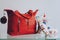 Fashion trend pair of stylish sneakers and big red handbag on shelf in a store, shop. Fall, autumn Sale, trend, shopping,