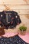 Fashion trends - black crop top / blouse in floral print on hangs on hanger, blue skirt, belt, bag and jewelry: hair pearl clip,