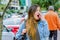 Fashion trendy casual young woman walking in the streets and yawning during a long day, wearing a jean jacket and black