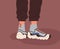 Fashion unisex sneakers and socks on human feet. Modern sport shoes pair, athletic footwear on legs in pants. Stylish