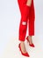 Fashion unrecognizable Lady in red pants and shoes. Minimalist elegant details style. Retro gloves and bracelets.  Lookbook