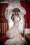 Fashion vogue photo beautiful bride with curly hair in a gorgeous wedding dress with precious perfect poses in amazing interior