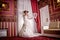 Fashion vogue photo beautiful bride with curly hair in a gorgeous wedding dress with precious perfect poses in amazing interior