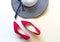 Fashion woman accessories set. Trendy fashion red shoes heels, stylish handbag clutch. Colorfull background.