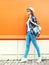 Fashion woman with backpack over colorful orange