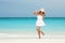 Fashion woman dancing on the beach. Happy island lifestyle.