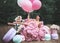 Fashion woman dressed in pink stunning dress surrounded of French Macarons