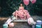 Fashion woman dressed in pink stunning dress surrounded of French Macarons