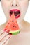 Fashion woman enjoy eating watermelon with red lips, red nail po