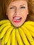 Fashion woman with necklace of small yellow bananas smiling