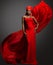 Fashion Woman in Red Dress and Hijab. African Model in Evening long Gown with flowing Silk Fabric over Dark Gray background.