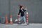 Fashion woman running down the street in front of the city tourist in stylish clothes with red lips and red beret