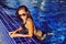 Fashion woman in sunglasses relaxing in the pool