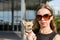 Fashion woman in sunglasses with small chihuahua in hands