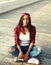 Fashion young african woman having fun in city, wearing red checkered shirt and baseball cap