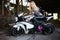 Fashion young blond woman on a sport motorcycle