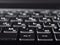 Fashionable backlit laptop keyboard on dark background