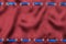 Fashionable beautiful background, blue satin ribbon inserted in red satin fabric