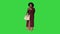 Fashionable Black woman standing and waiting on a Green Screen, Chroma Key.
