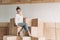 Fashionable businesswoman in formalwear sitting on wooden cubes