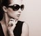 Fashionable chic female model profile in fashion sun glasses posing. Black and white portrait