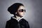 Fashionable child boy in sunglasses. Kid in Black cap. Autumn style. Winter.Little boy