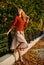 Fashionable clothes. Girl gorgeous blonde. Femininity and tenderness. Woman walking in autumn park. Pleated skirt