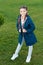 Fashionable coat. Girl cute face braided hair posing coat in spring park. Clothing for spring walks. Little fashion