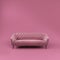 Fashionable comfortable stylish pink fabric sofa with black legs on pink background with shadow. Pink interior, showroom, single