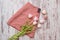 Fashionable concept. Pink skirt, glasses and pink tulips. Top view, light wooden background