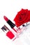 Fashionable cosmetics with a fresh red rose