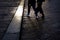 Fashionable couple walking on the wet floor of a floor with cobblestones