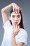 Fashionable emotional woman standing and showing her amazing red nails