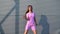 Fashionable funky woman in pink sportswear performing outdoor street dancing. 4k Dragon RED camera