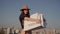 Fashionable girl holds shopping bags against the blue sky