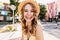 Fashionable girl laughing to camera while resting in summer day. Blissful caucasian female model en