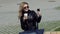 Fashionable girl in leather jacket taking a selfie on smartphone