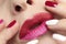 Fashionable glamorous manicure and lip makeup with red pink lipstick