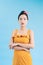 Fashionable graceful Young woman posing on blue background. Romantic adorable girl in polka dot yellow dress