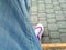 Fashionable Jeans in macro and colorful purple sneaker in background