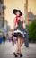 Fashionable lady wearing black hat posing on the street