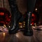 Fashionable leather black women`s winter boots. Young woman in jeans in stylish shoes stands in a room near the holiday mirror