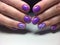 fashionable lilac manicure with a white design