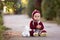 Fashionable little toddler boy with knitted outfit, walking in a