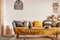 Fashionable living room interior with yellow and grey design and long coffee table in the middle